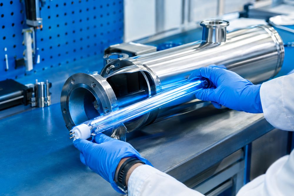 Technician handling a quartz sleeve and UV-C lamp